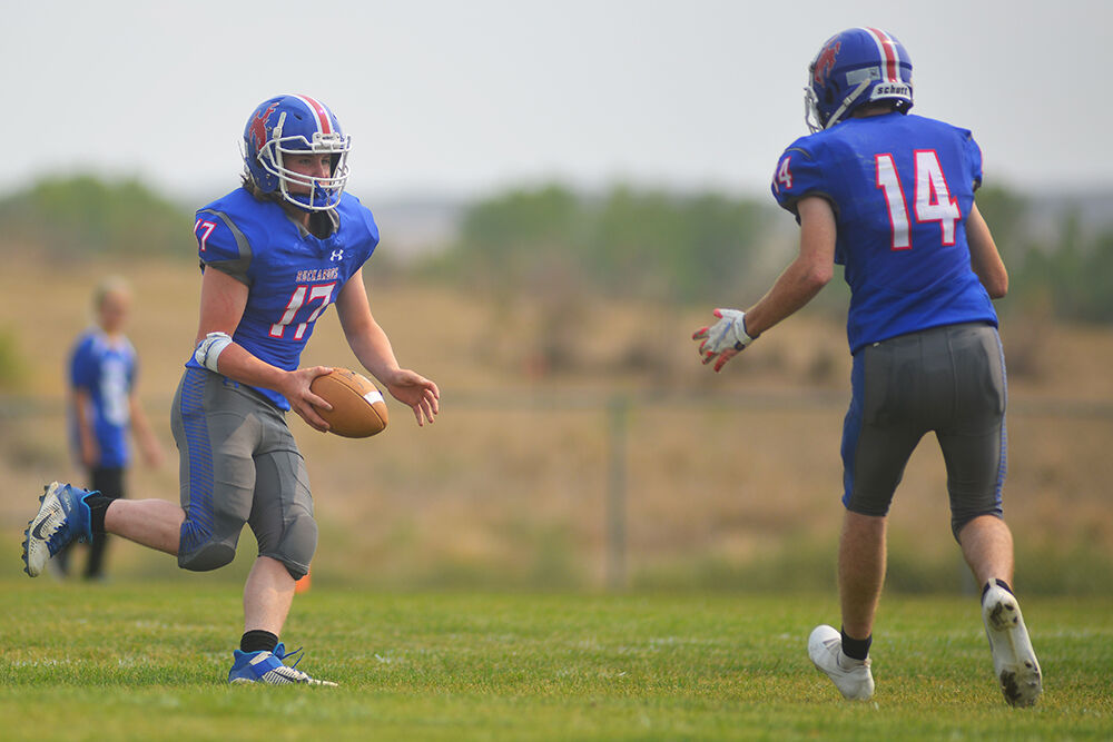 Grady Alger passes the ball off to senior Sam Ramsbottom